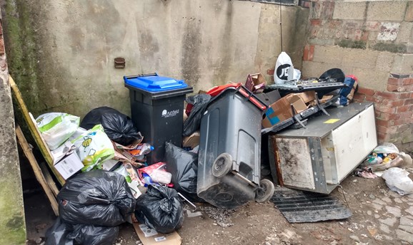 Overflowing waste at bin collection point Sutton in Ashfield