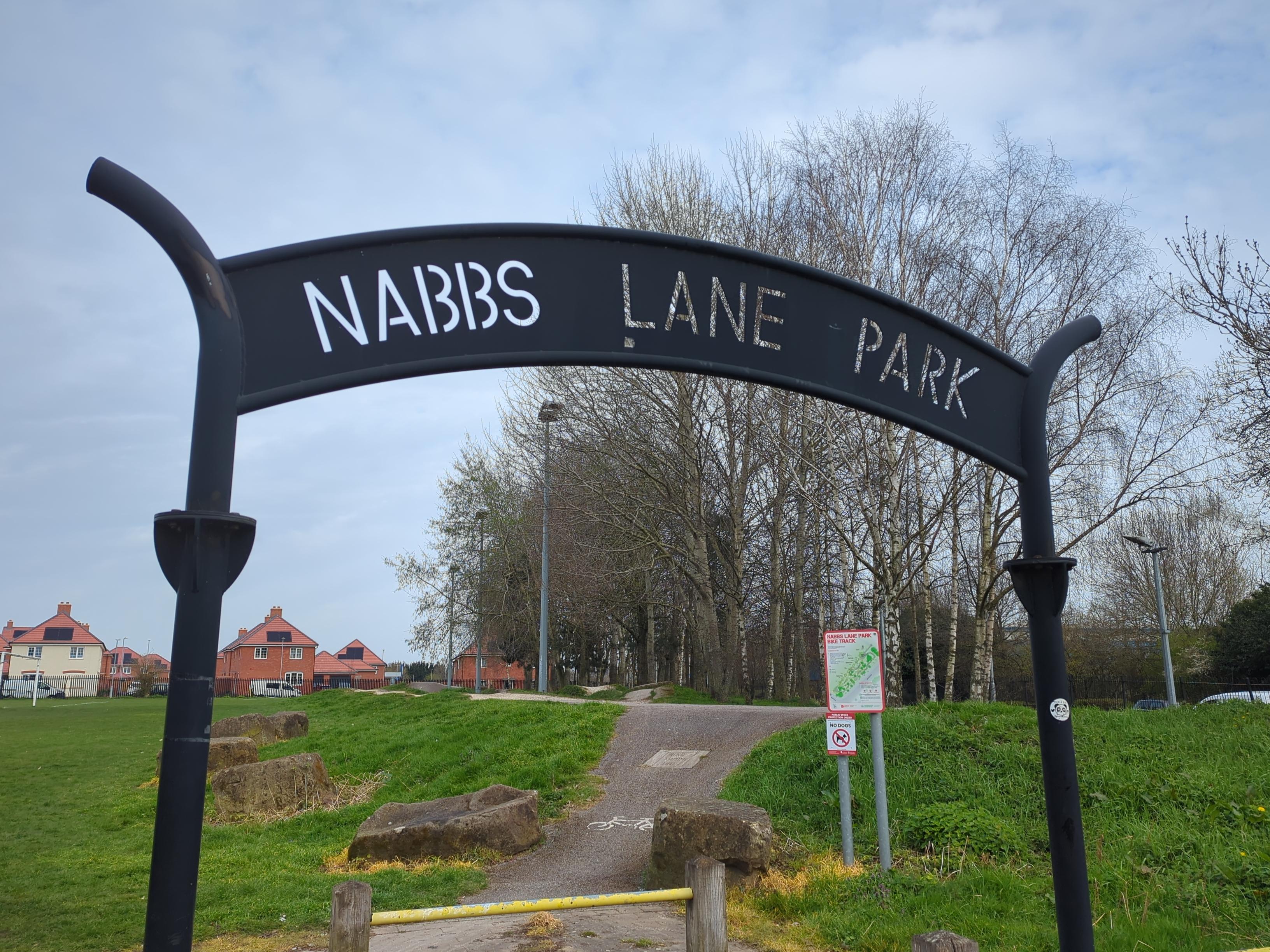 A metal archway that spells out Nabbs Lane Park 
