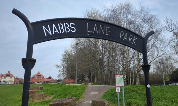 A metal archway that spells out Nabbs Lane Park 