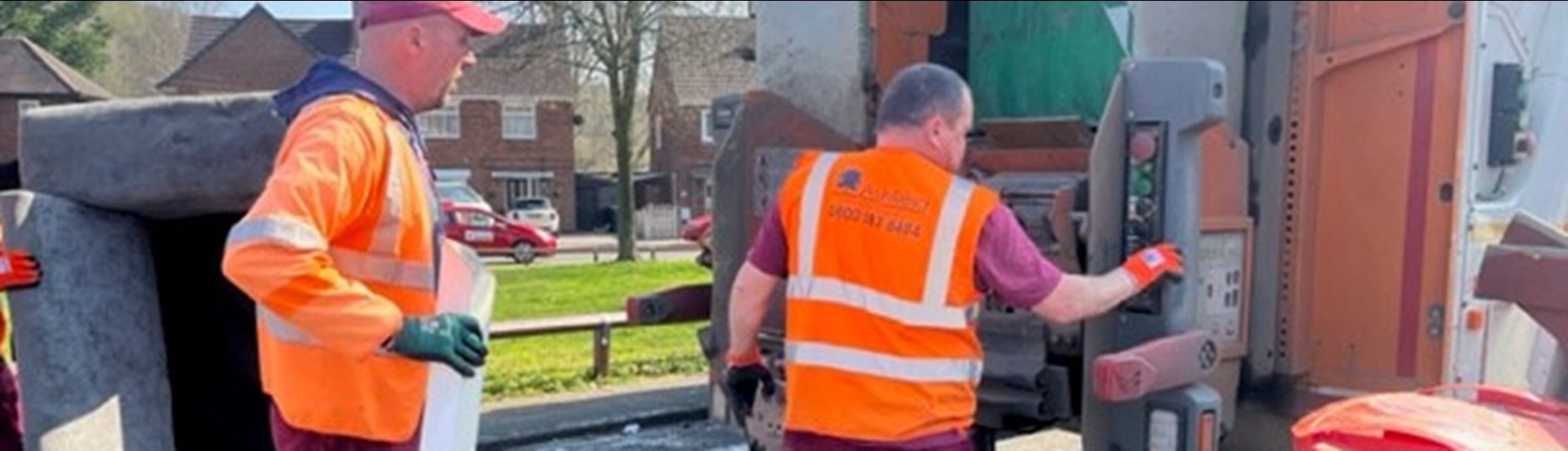 Council worker collecting bulky items and loading onto refuge vehicle 