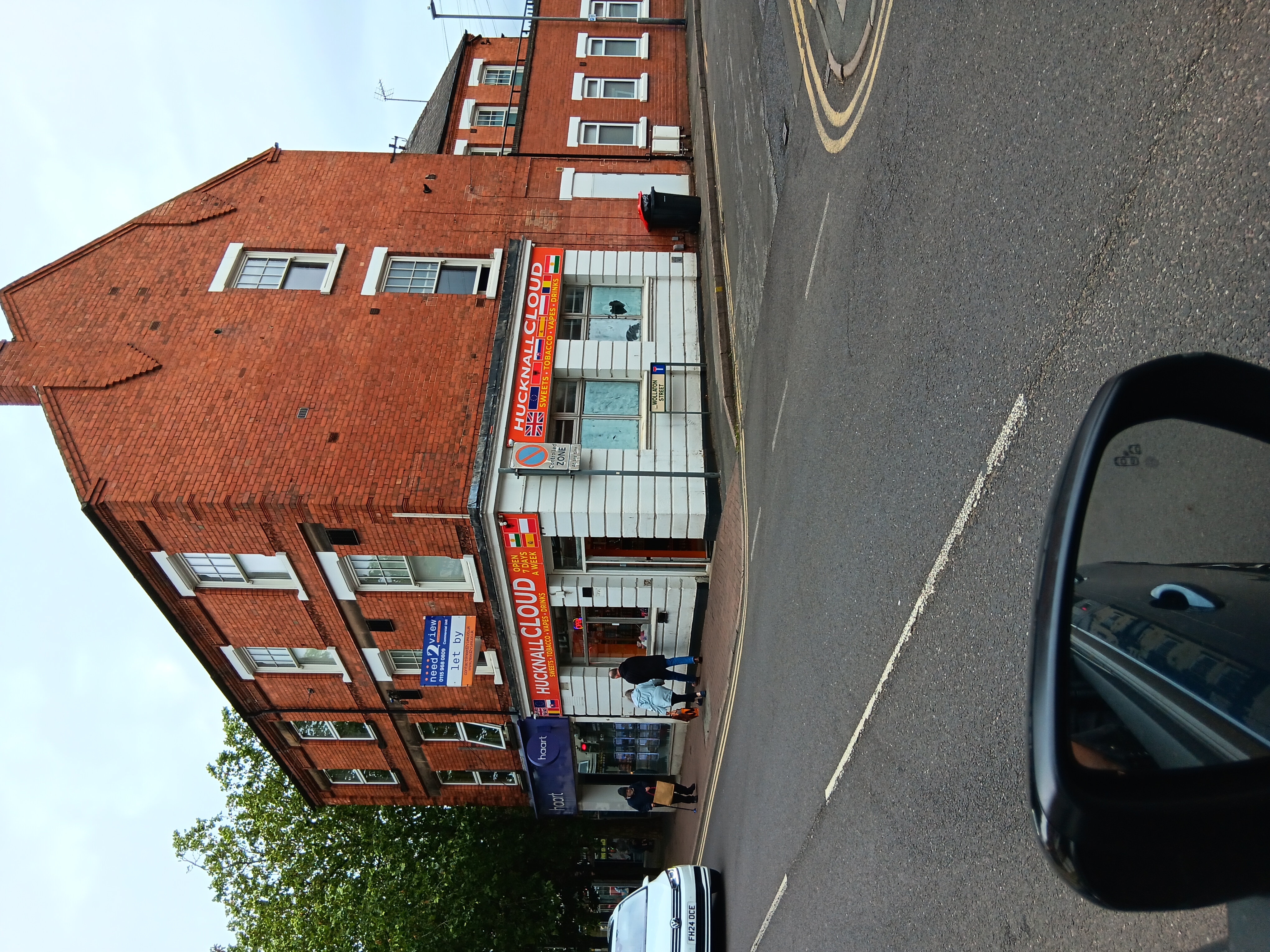 A shop with white walls and an orange sign that reads Hucknall Cloud