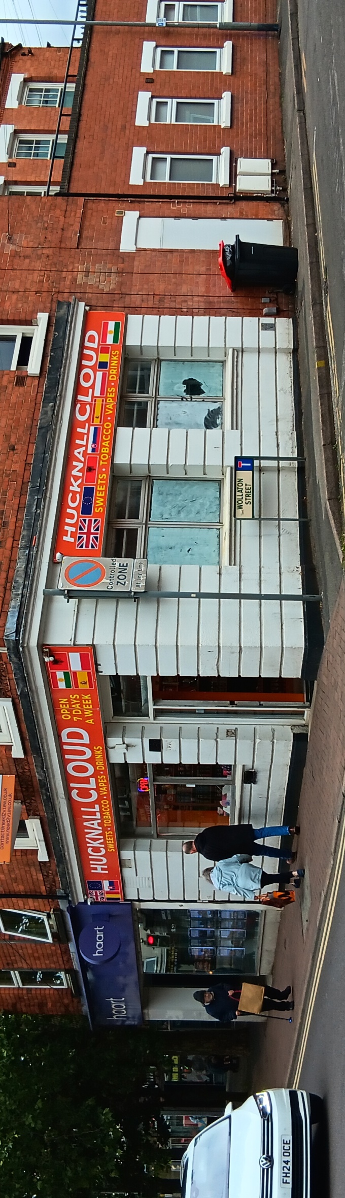 A shop with white walls and an orange sign that reads Hucknall Cloud