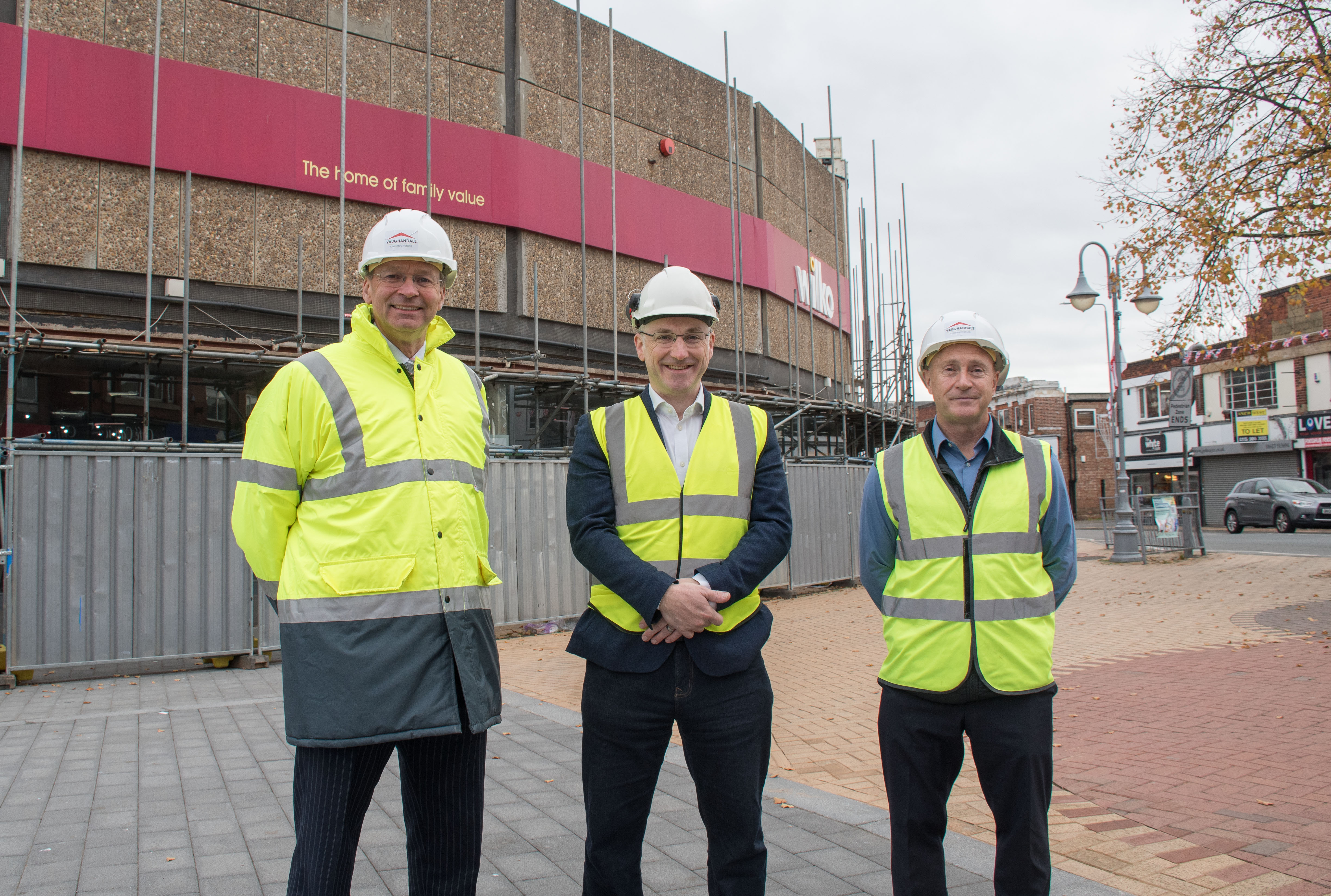 Andrew Cropley, Cllr Mattew Relf and Darren Atkins, all stand in high vis vests in front of Wilkos 