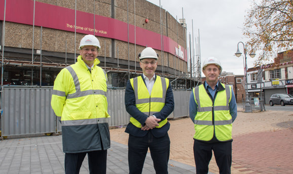 Andrew Cropley, Cllr Mattew Relf and Darren Atkins, all stand in high vis vests in front of Wilkos 