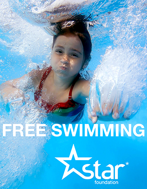 Young girl swimming underwater with words Free Swimming Star Foundation