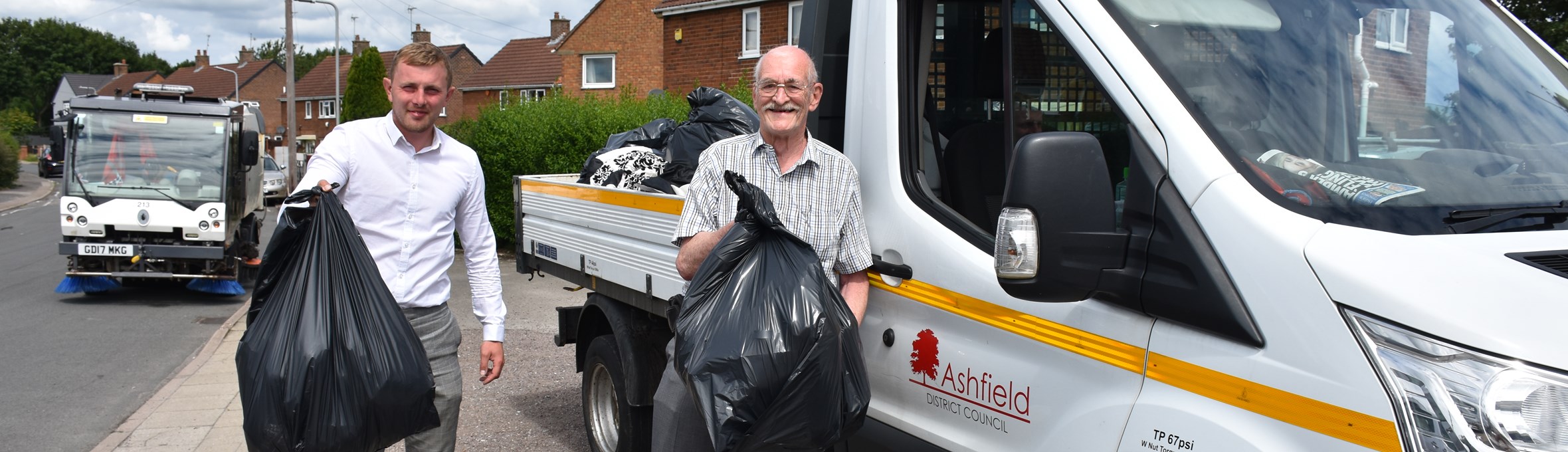 Men holding rubbish bags