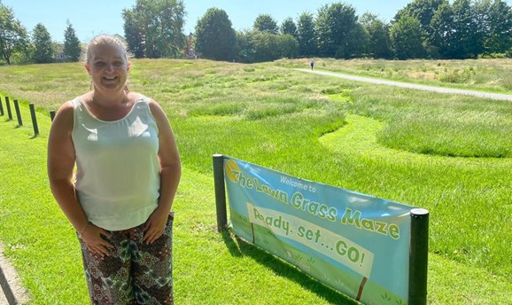 Samantha Deakin standing next to a grass maze
