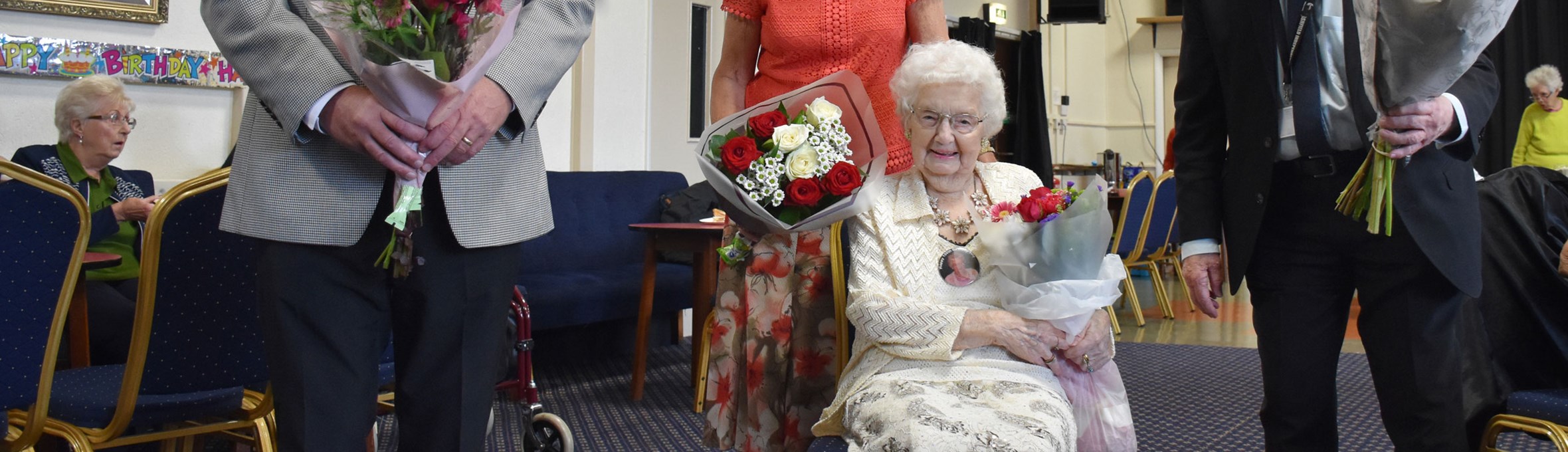 Hilda Tilcock sitting with flowers