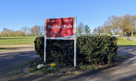 A red sign saying Welcome to Titchfield Park 