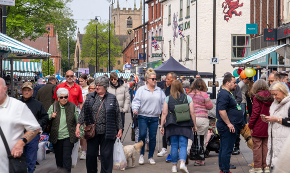 A crowd of people walking through and shopping at Hucknall High Street