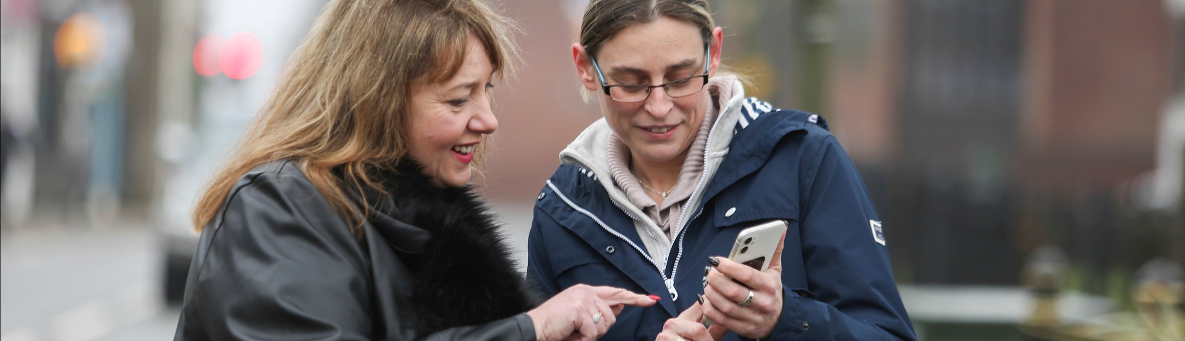Police and Crime Commissioner and Cllr Helen-Ann Smith looking at a mobile phone 