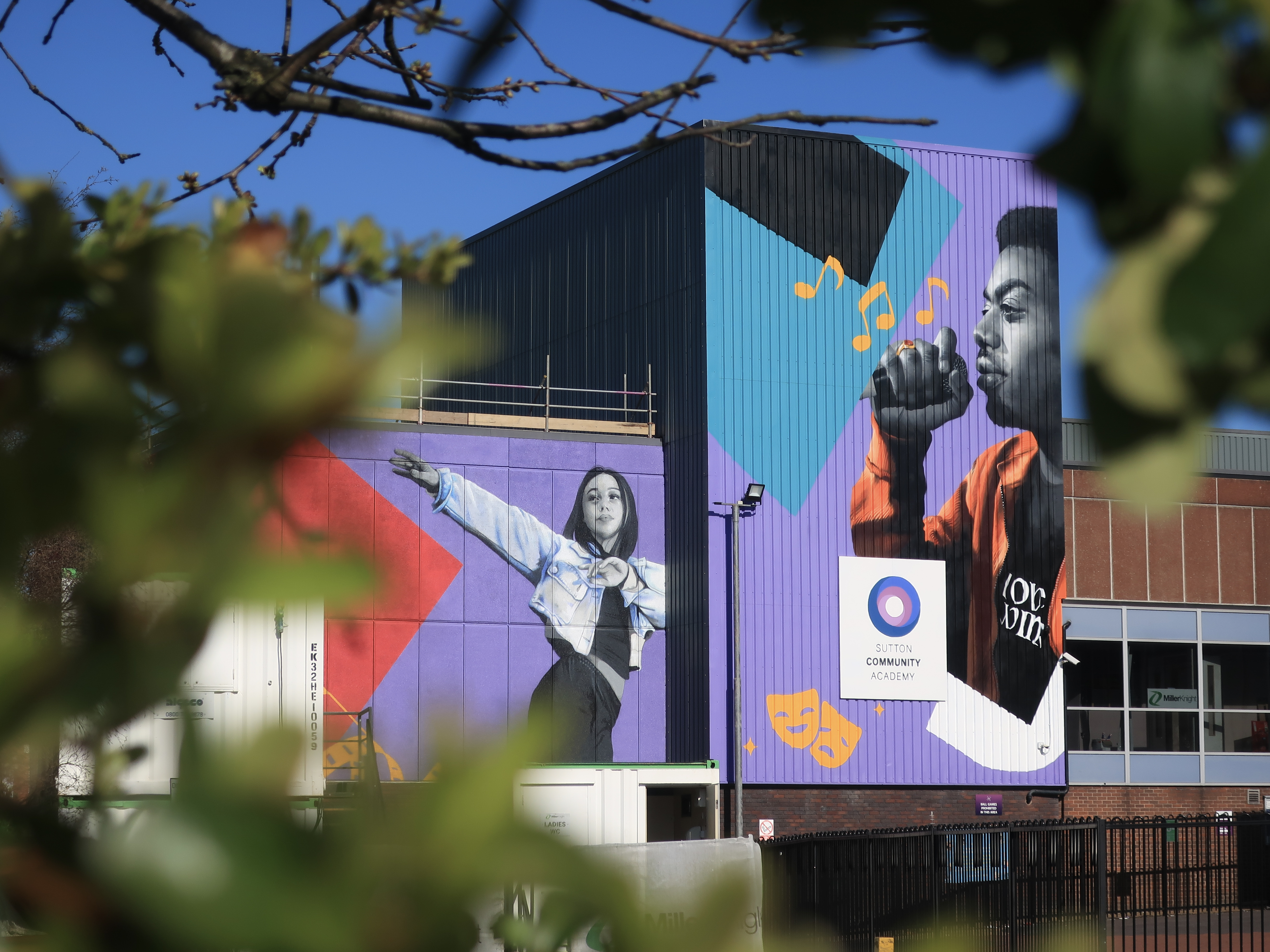 Two photo-realistic murals painted on the side of Cornerstone Theatre in Sutton 