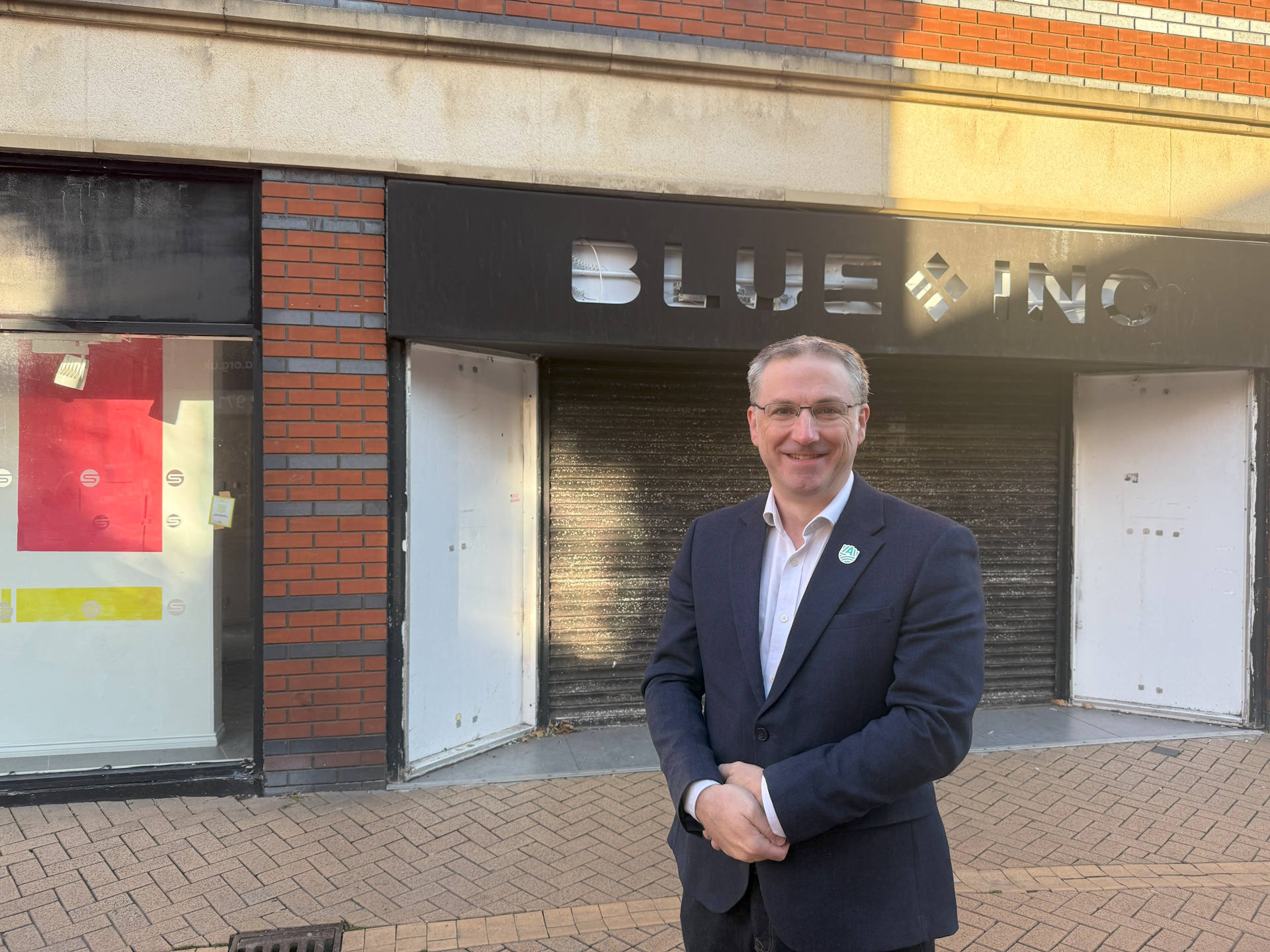 Cllr Matthew Relf on Low Street, Sutton, standing in front of empty shops.