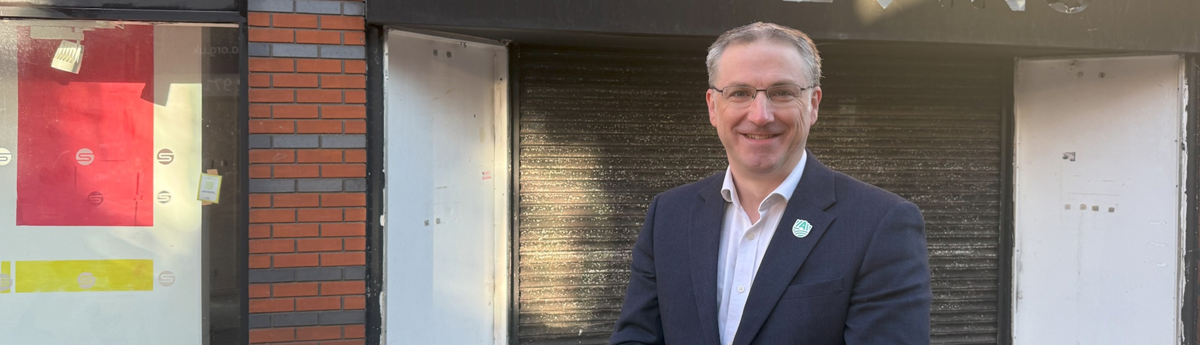 Cllr Matthew Relf on Low Street, Sutton, standing in front of empty shops.