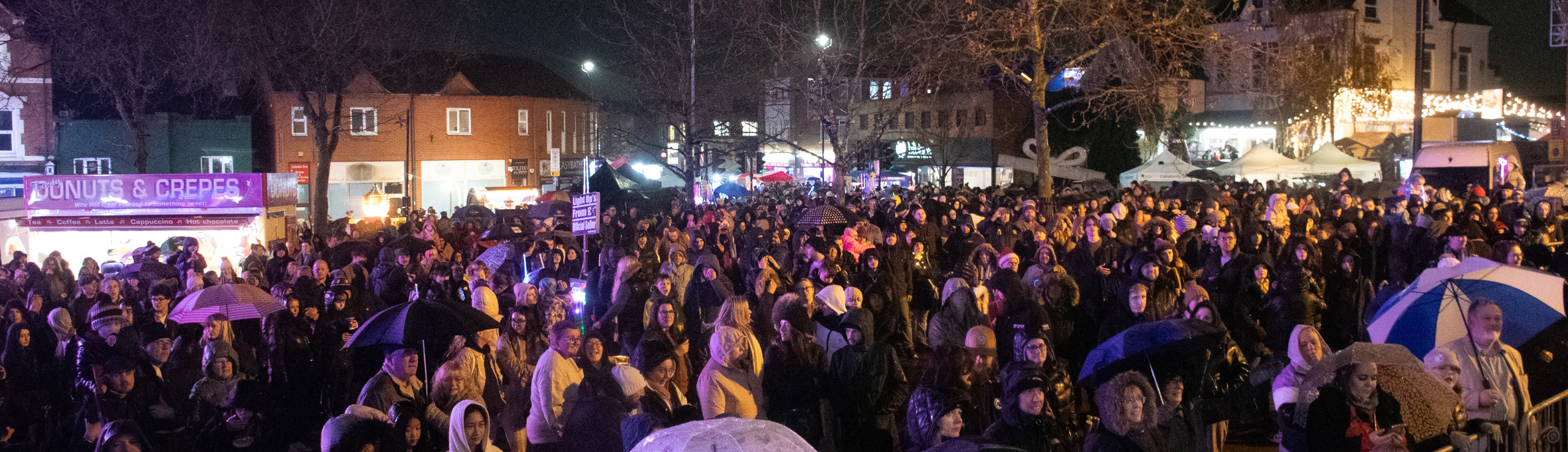 a huge crowd watches a stage on Hucknall market place