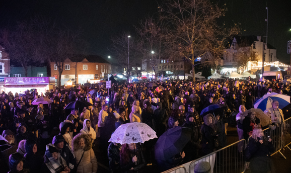 a huge crowd watches a stage on Hucknall market place 