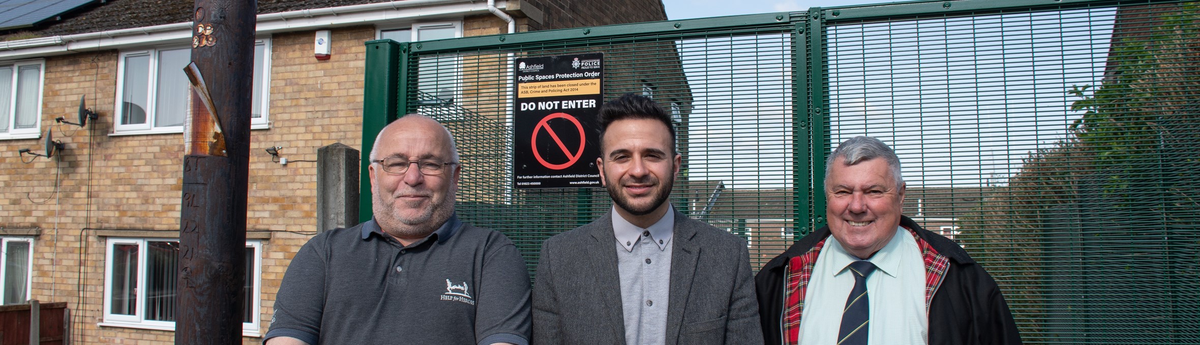Cllr Andy Meakin, Antonio Taylor, and Cllr Warren Nuttall outside the gate on Beacon Drive 