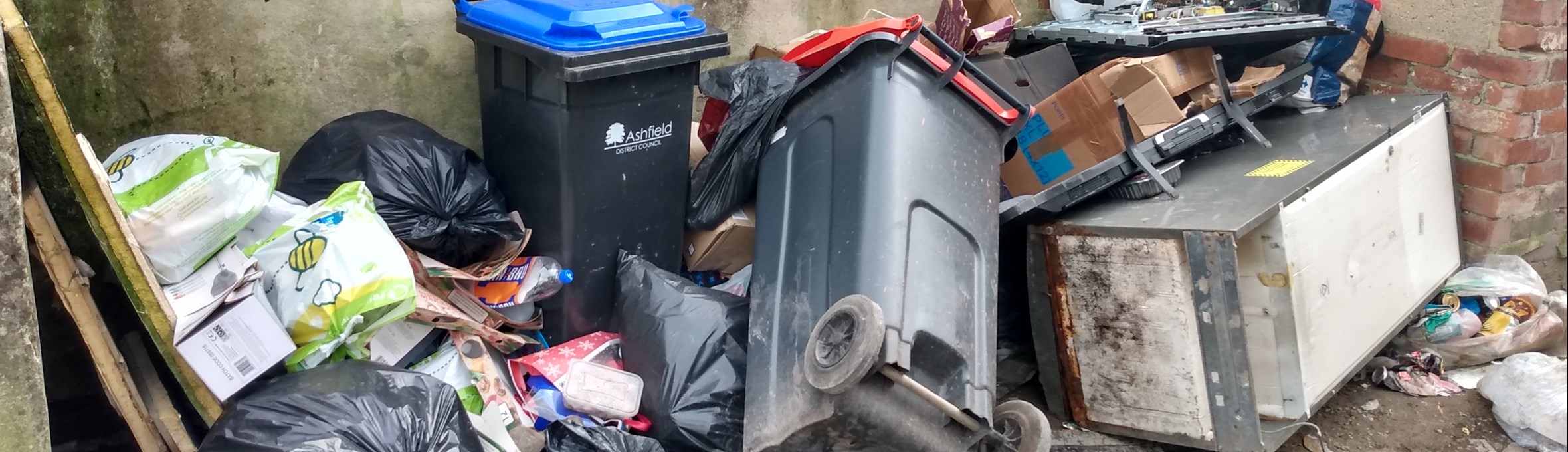 Overflowing waste at bin collection point Sutton in Ashfield