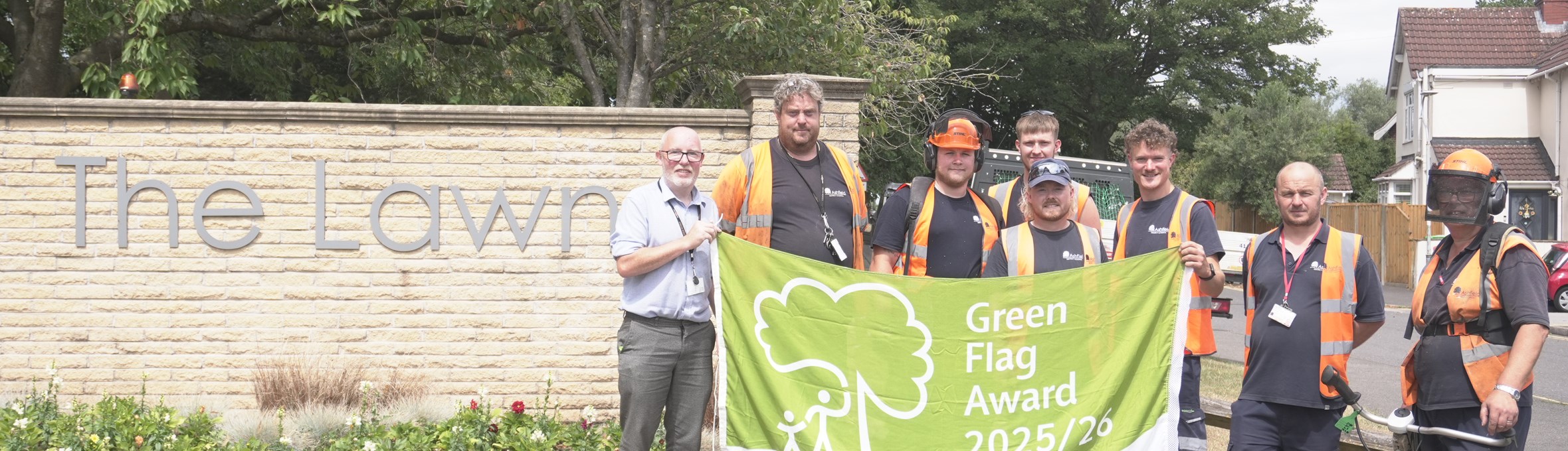 Members of Sutton Lawn staff holding a Green Flag to celebrate its green flag award status