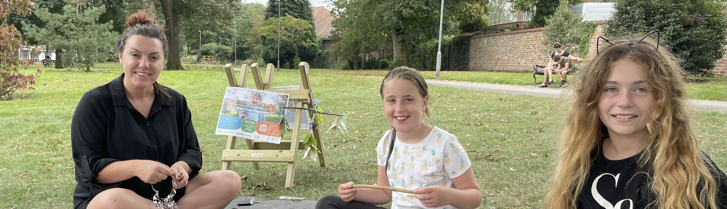 A woman and two girls craft making at Mill Waters