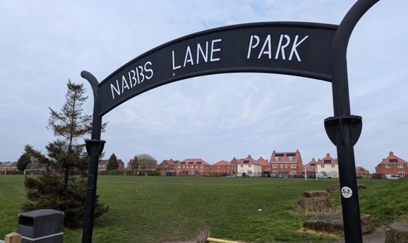 A metal sign that reads Nabbs Lane Park