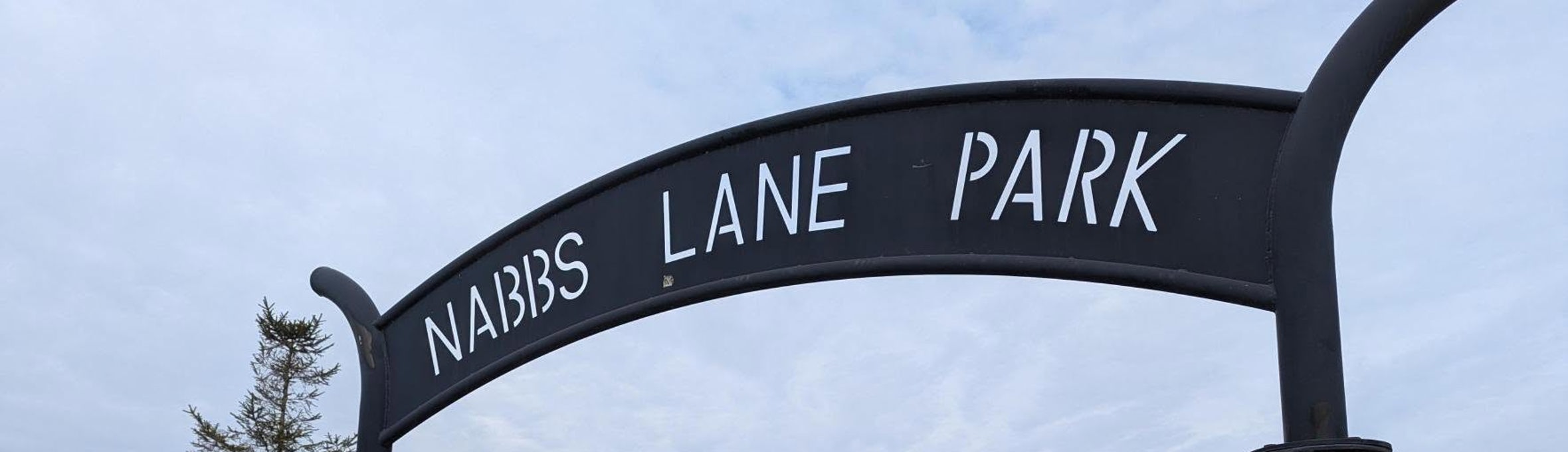 A metal sign that reads Nabbs Lane Park