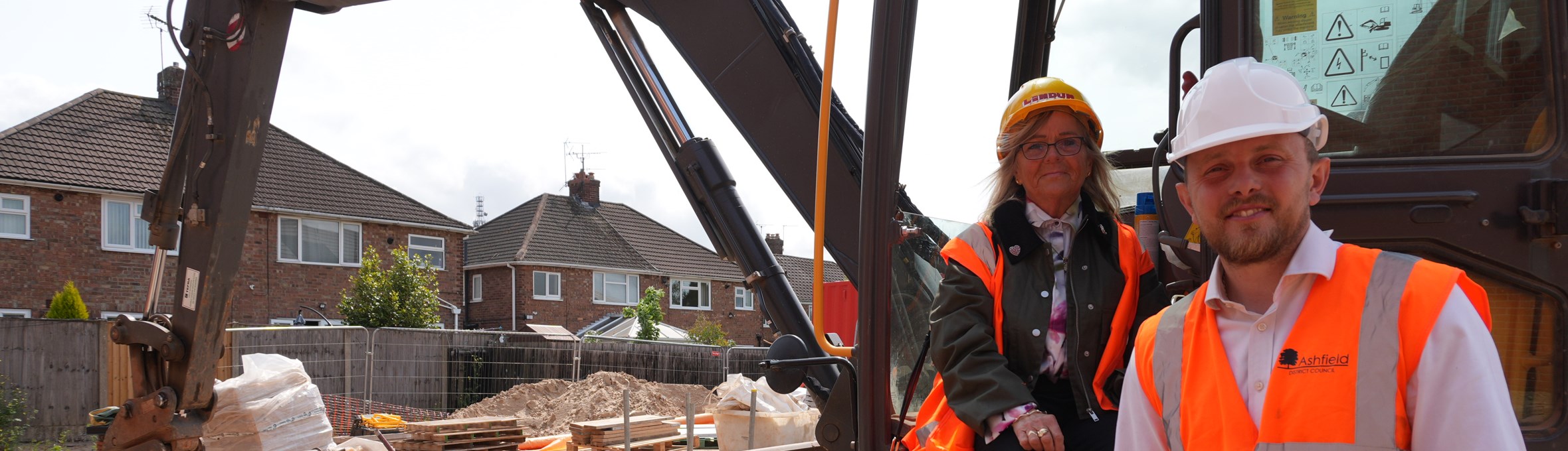 Diane Sheldon with Cllr Tom Hollis at the housing development named after son