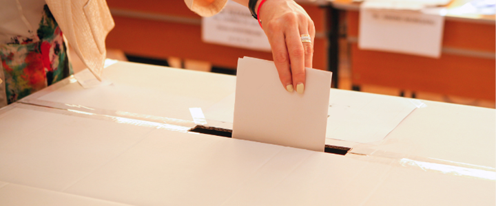 Voting slip being placed into a ballot box