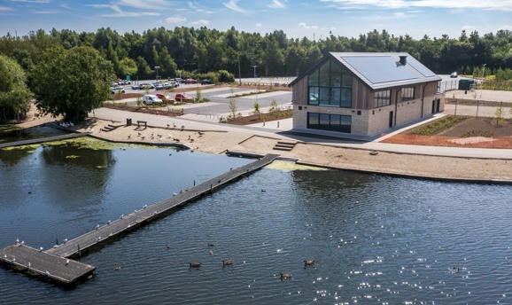 A stone and timber building with large windows overlooking Kings Mill Reservoir 