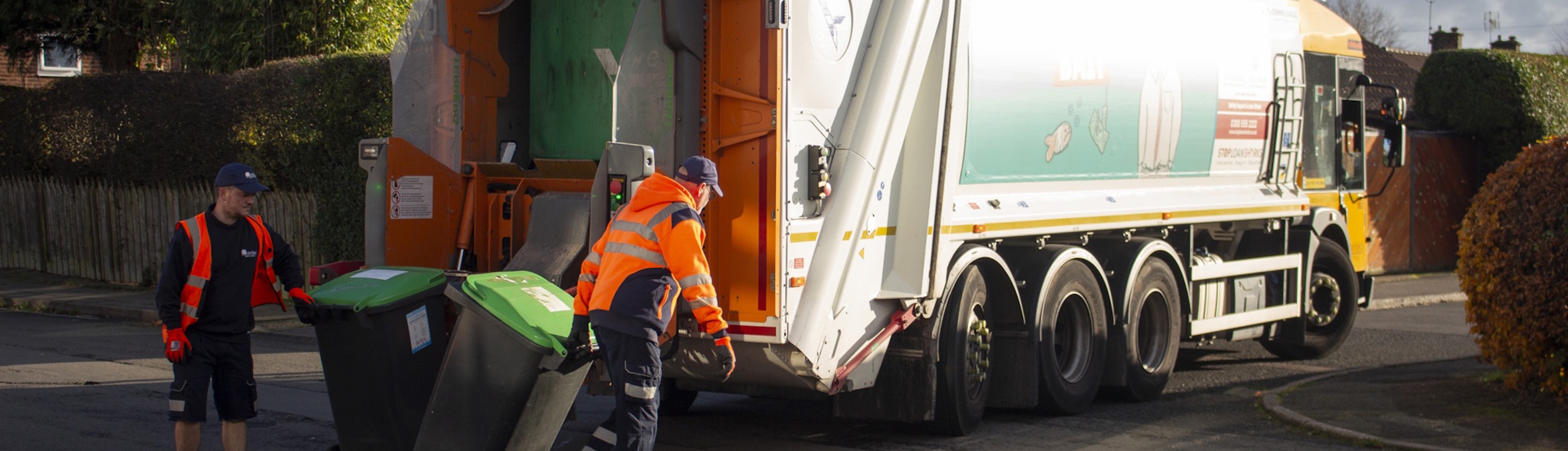 Ashfield District Council refuse collectors loading bins into a refuse truck