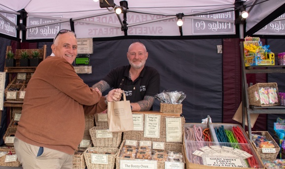 Someone making a purchase at an Ashfield Food and Drink Festival stall